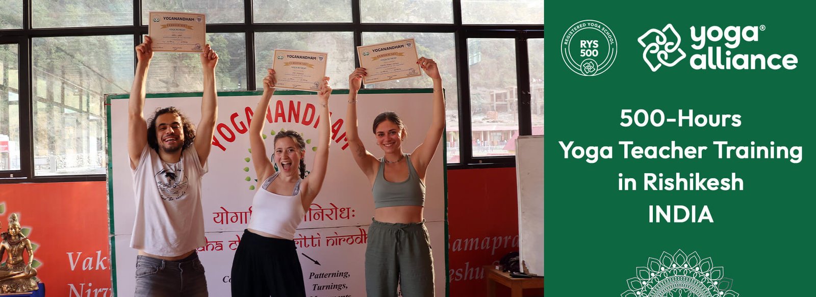 Graduates holding certificates at 500-hour Yoga Alliance teacher training in Rishikesh, India.